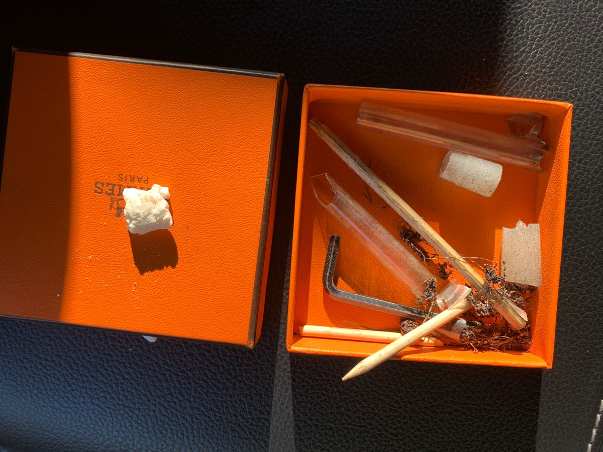 Orange box containing assorted objects